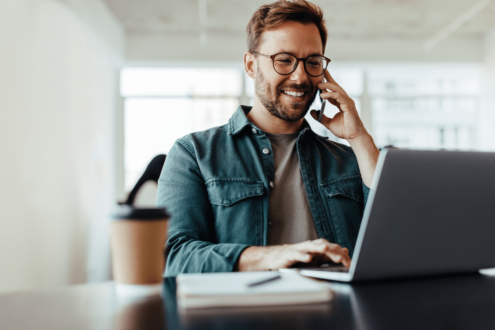 business man sitting in front of a laptop