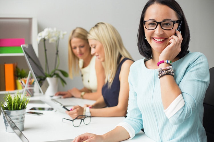 Woman calling on phone in the office